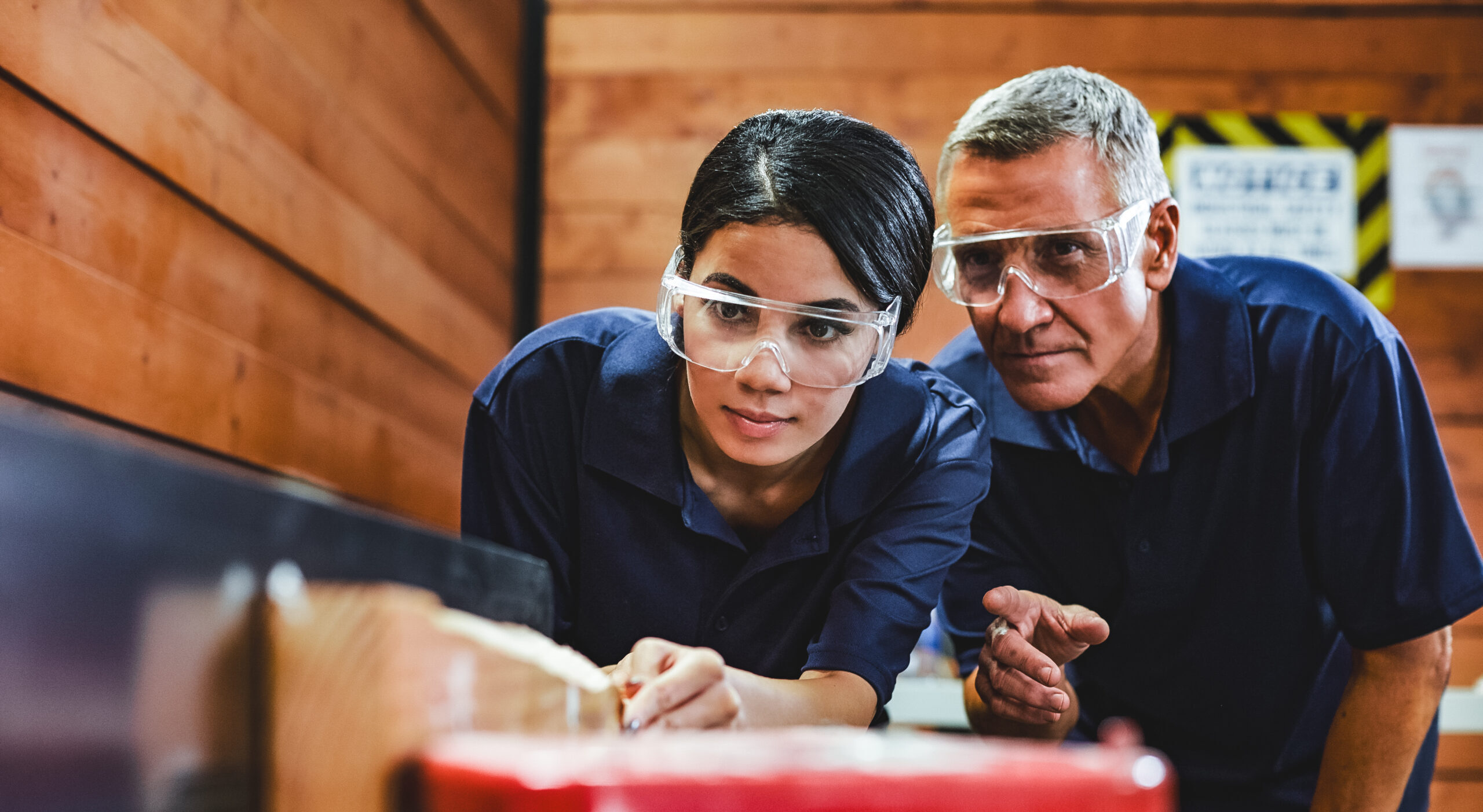 Carpenter Training Female Apprentice To Use Plane