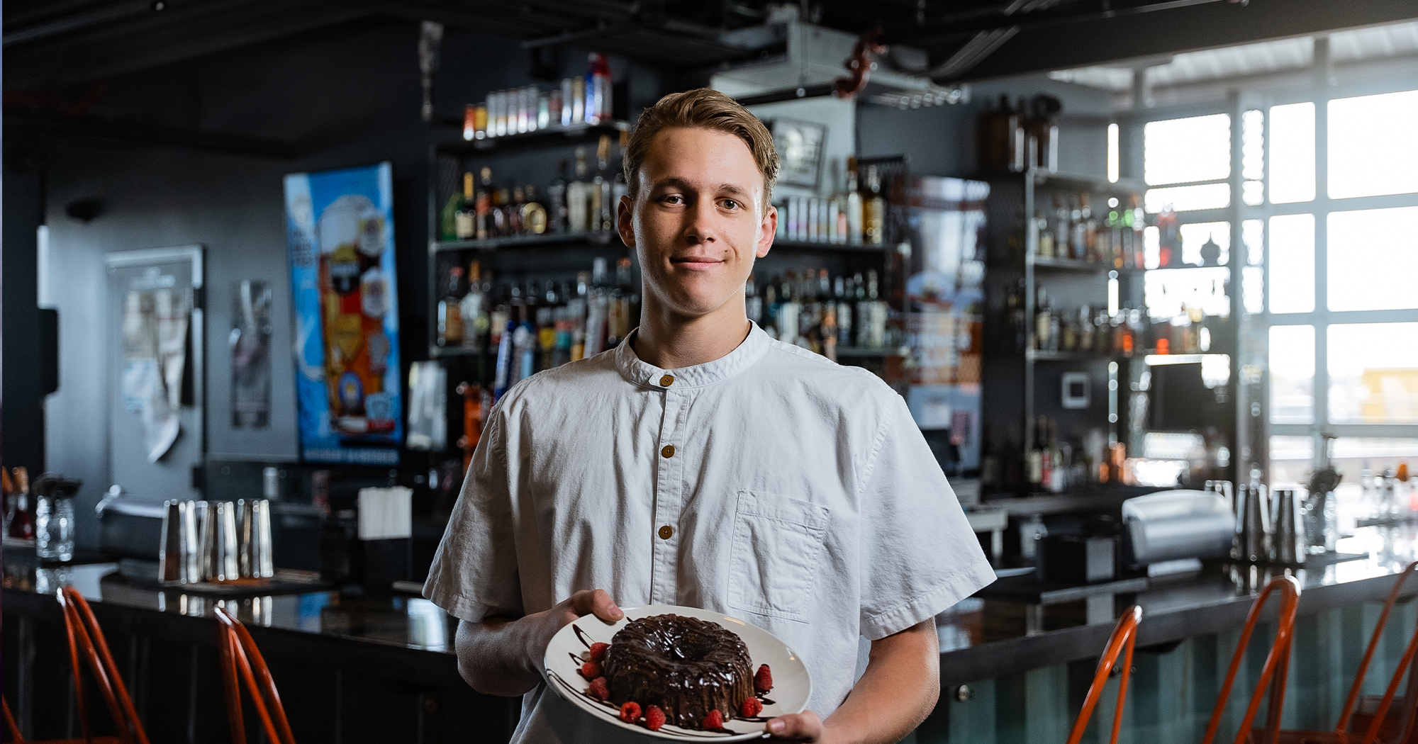 Male Wyoming apprentice holds a plated cake